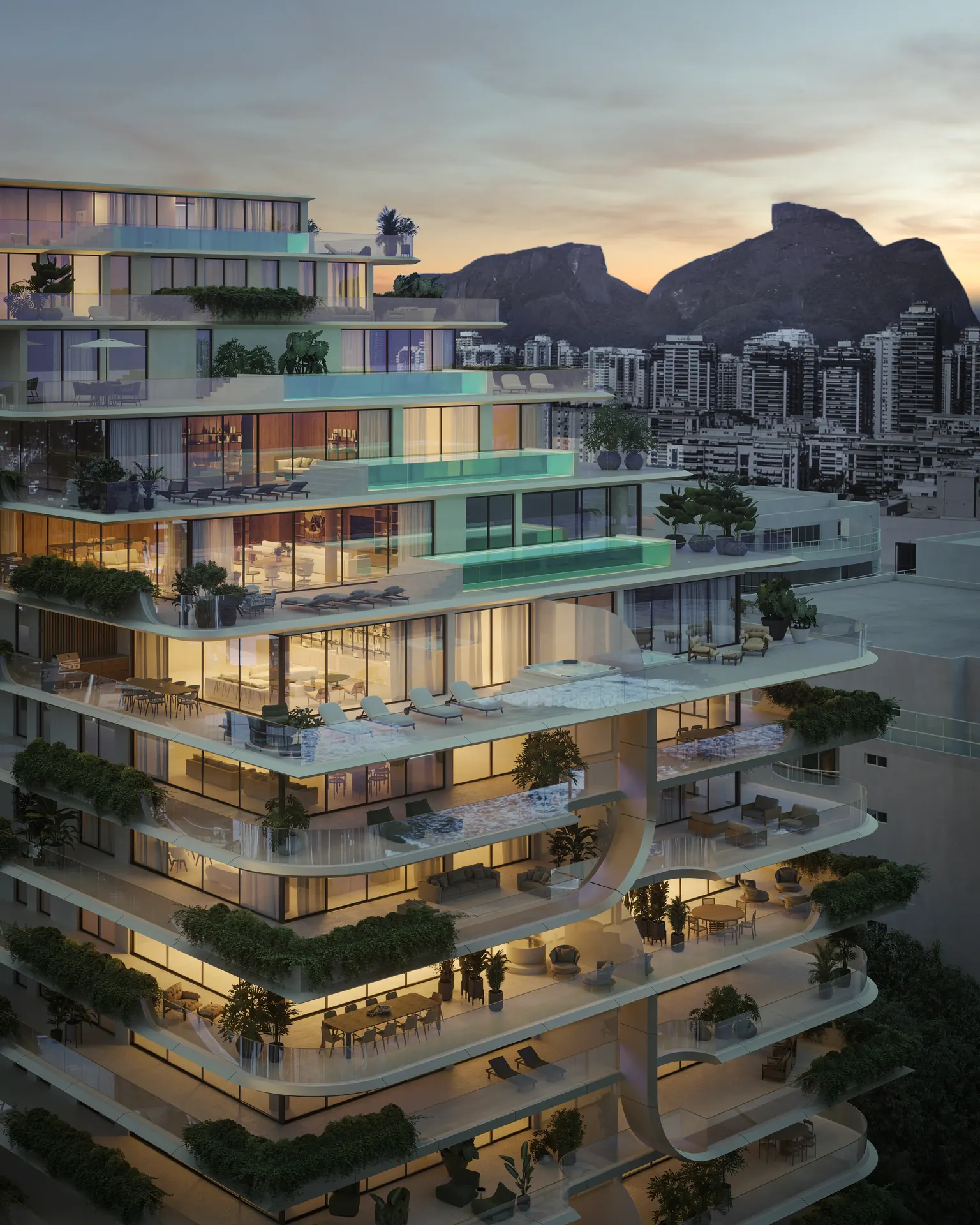 Fachada do Atto com varandas curvas e jardins, com a Pedra da Gávea ao fundo ao entardecer