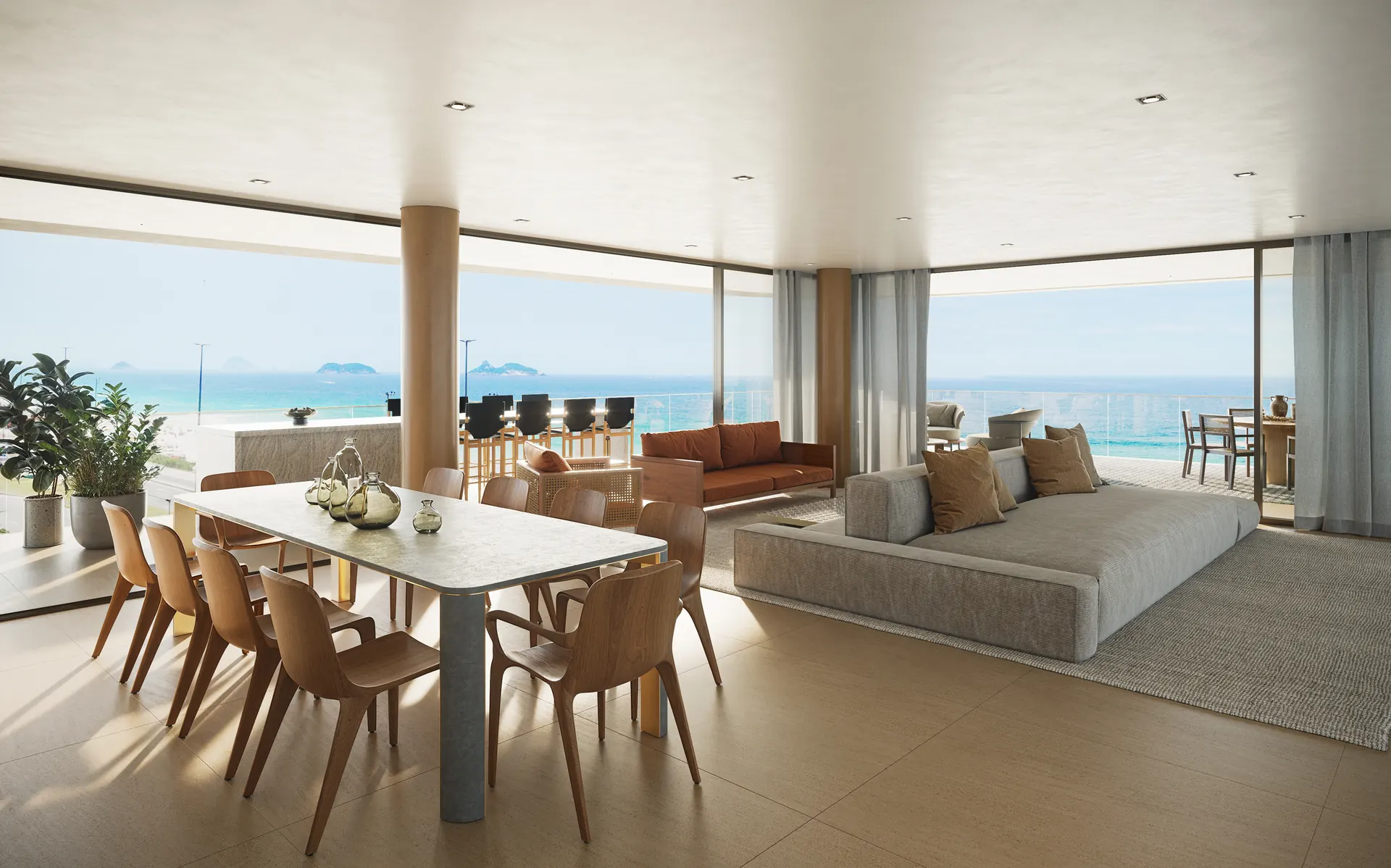 Sala de jantar integrada ao estar, com a praia da Barra ao fundo