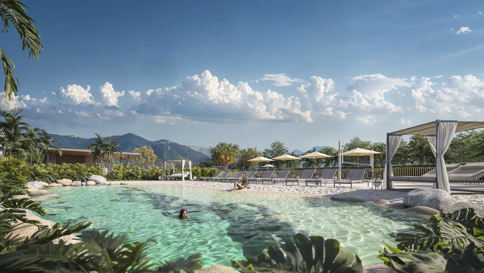 A piscina natural do condomínio, com água turquesa, areia, cabana e as montanhas ao fundo