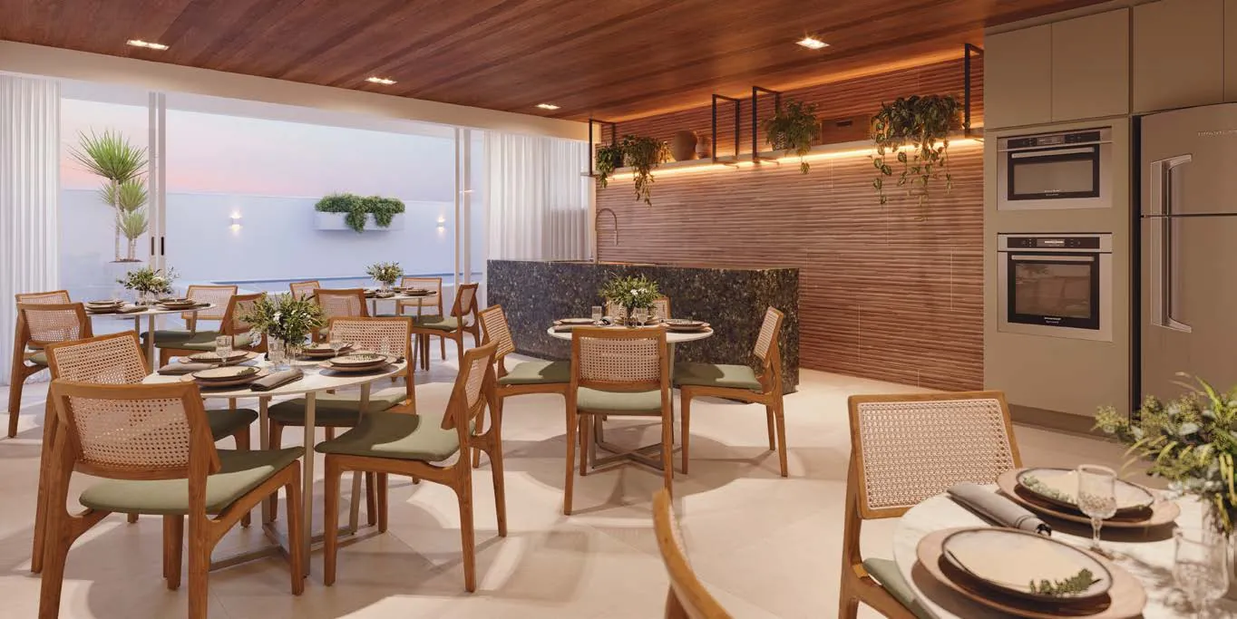 O espaço gourmet do Basílio Tijuca, com mesas postas e cozinha