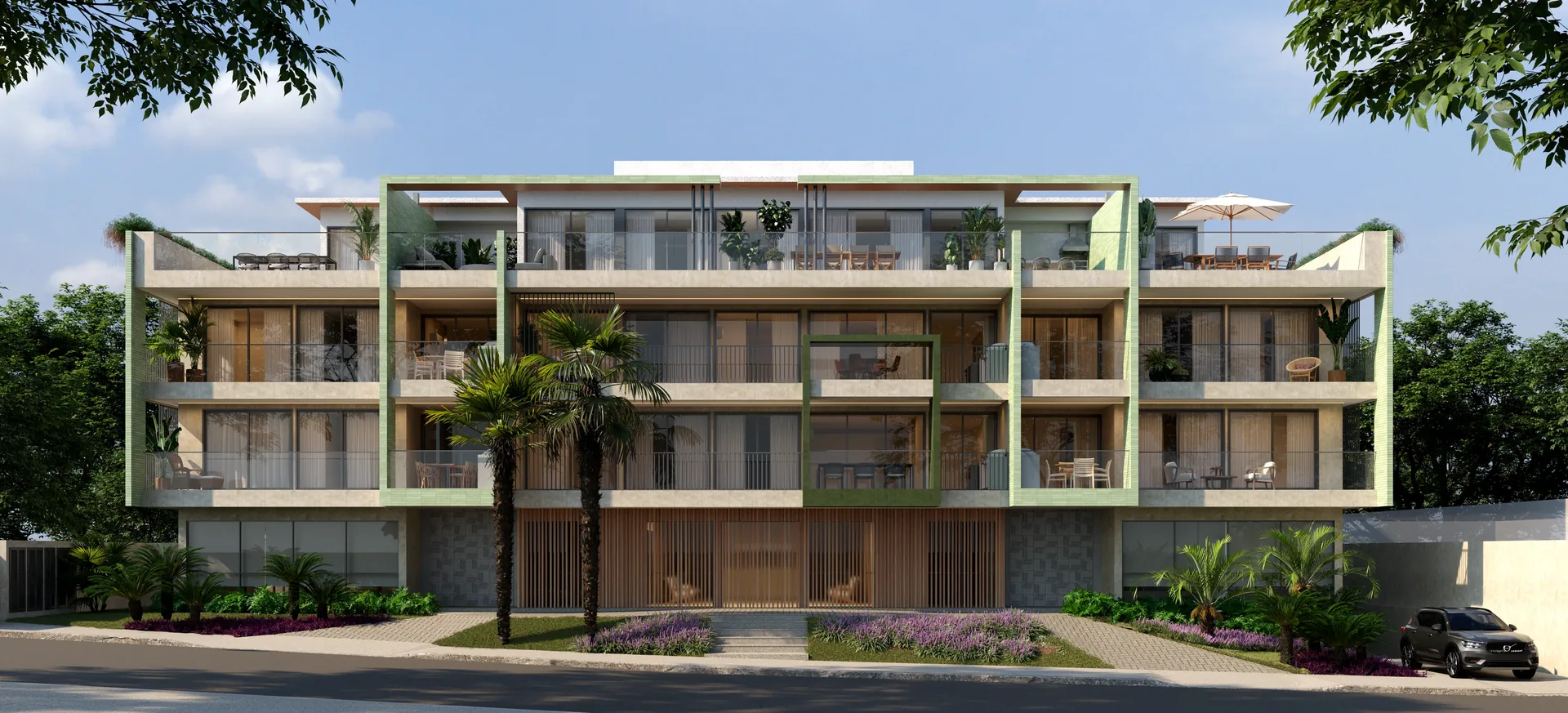 Fachada do B. Unique: três pavimentos em tons de areia, com molduras verdes e palmeiras à frente