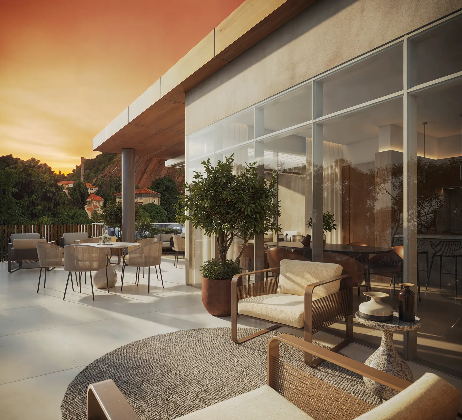 Lounge externo do rooftop com mesas, poltronas e oliveiras