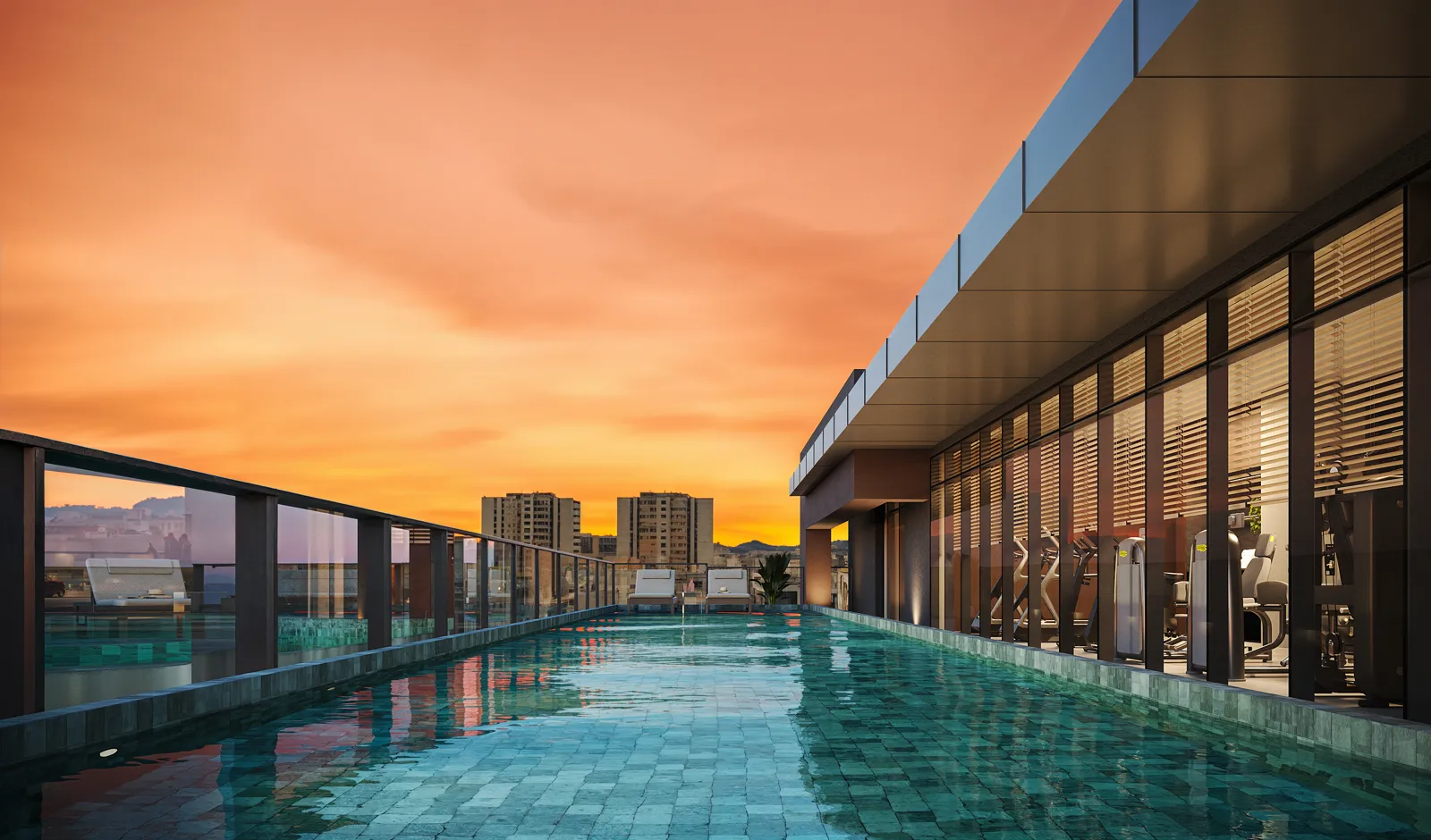 Piscina de raia no rooftop ao entardecer, com prédios de Laranjeiras ao fundo