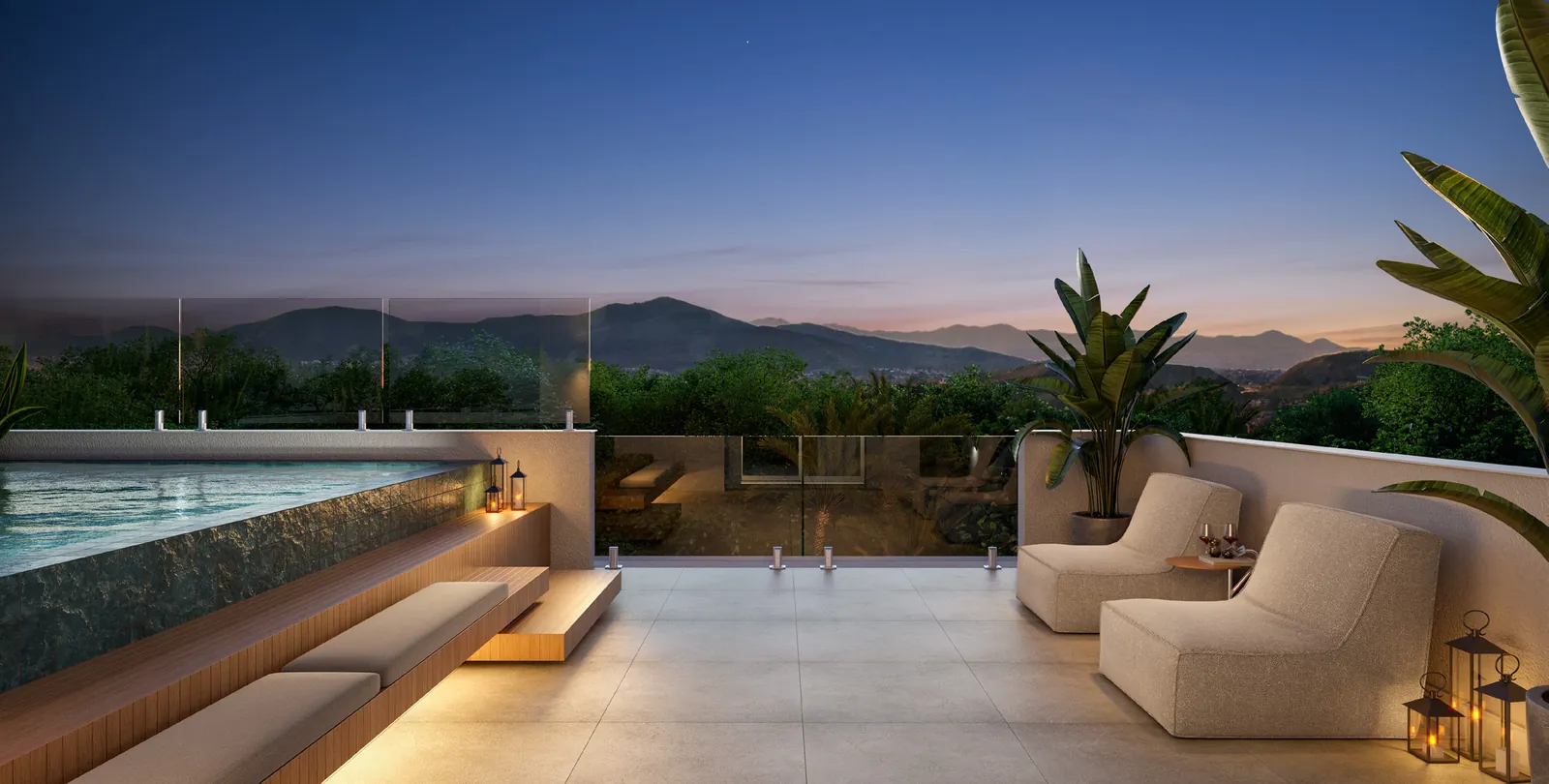 Terraço da casa da Alameda à noite, com sofás e vista para a montanha