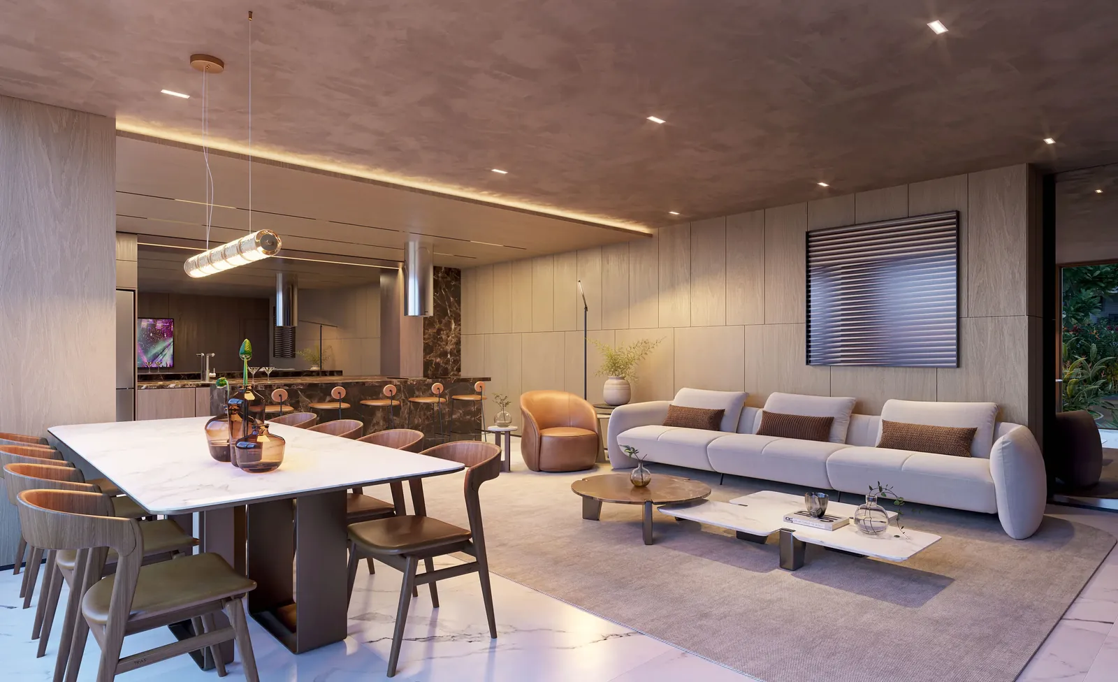 Espaço gourmet com bancada, mesa de jantar e sofás