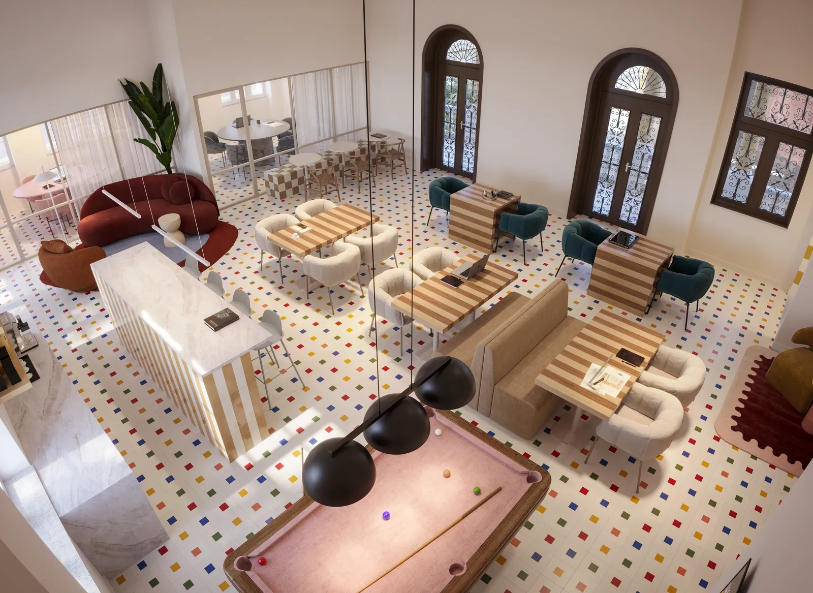O hub criativo dentro do casarão, com mesa de sinuca, sofás e janelas em arco