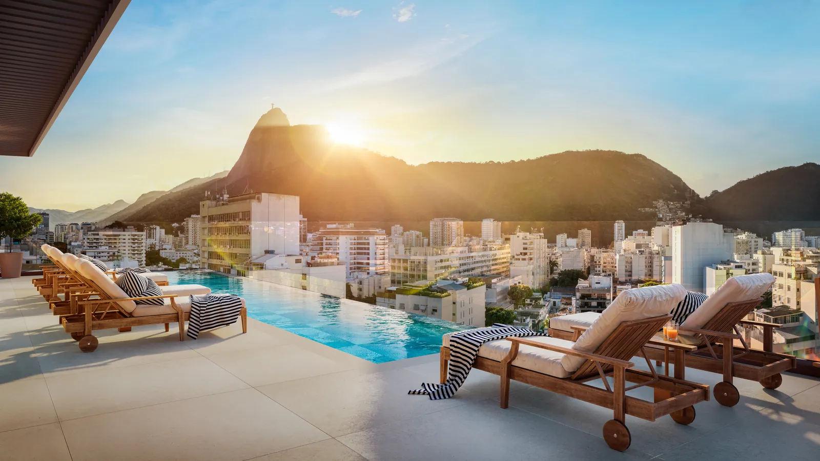 Piscina do terraço com espreguiçadeiras e o Cristo ao fundo