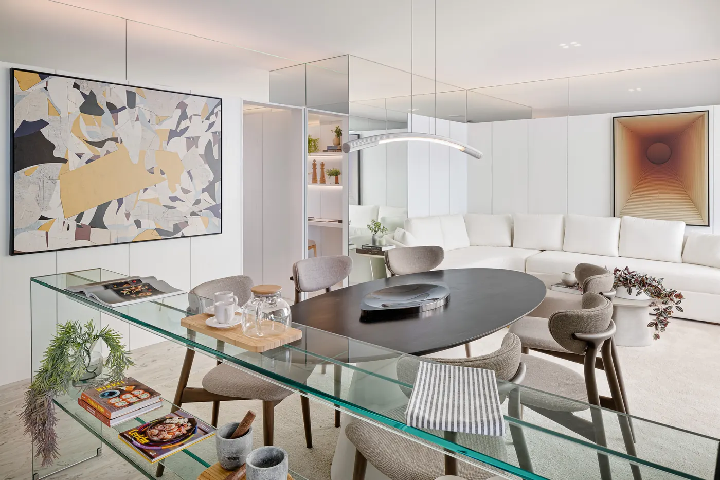 Sala de jantar do decorado de 3 suítes, com mesa de vidro e quadro colorido