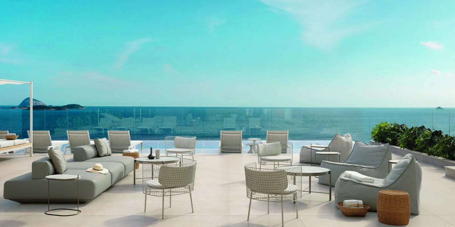 O terraço descoberto do rooftop do Ipa, com sofás e vista para o mar