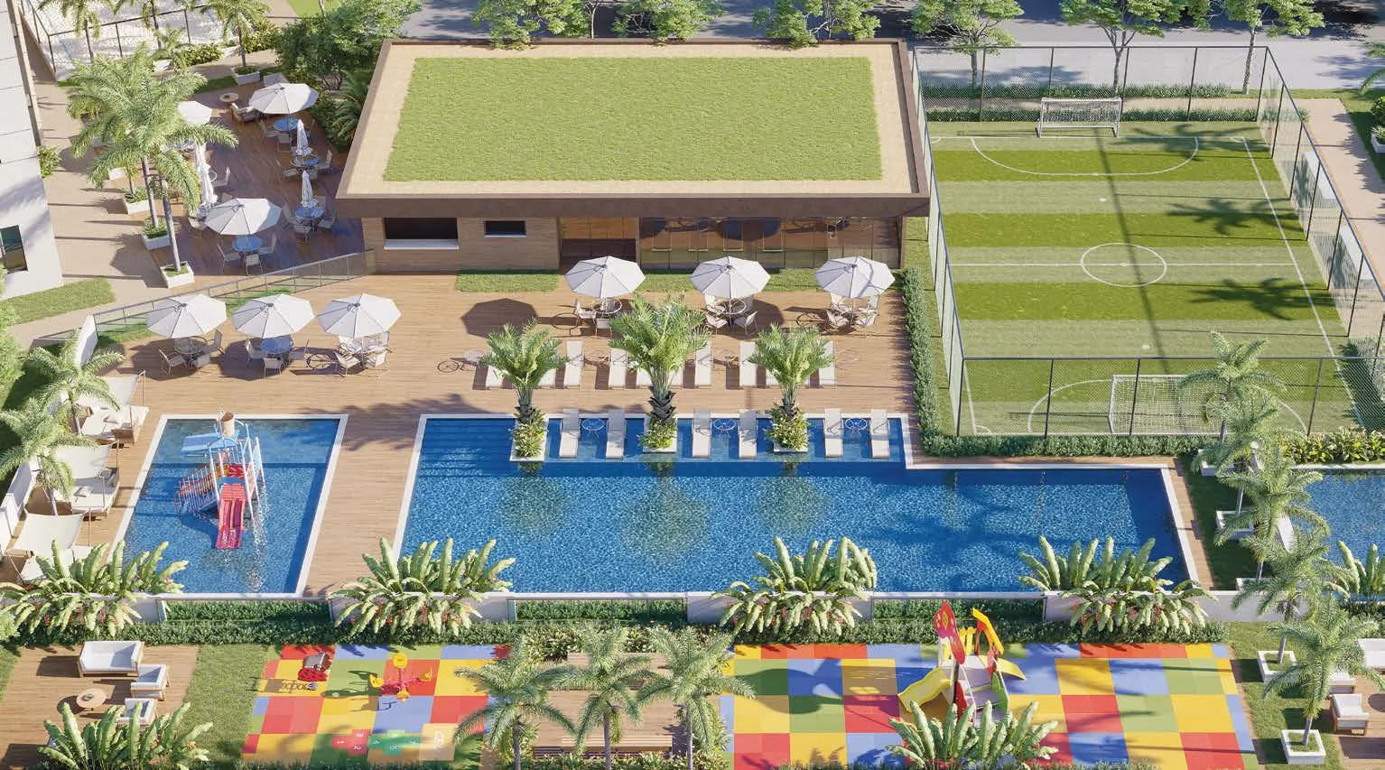 Vista do alto do lazer do Jardim da Barra, com piscinas, campo gramado e playground
