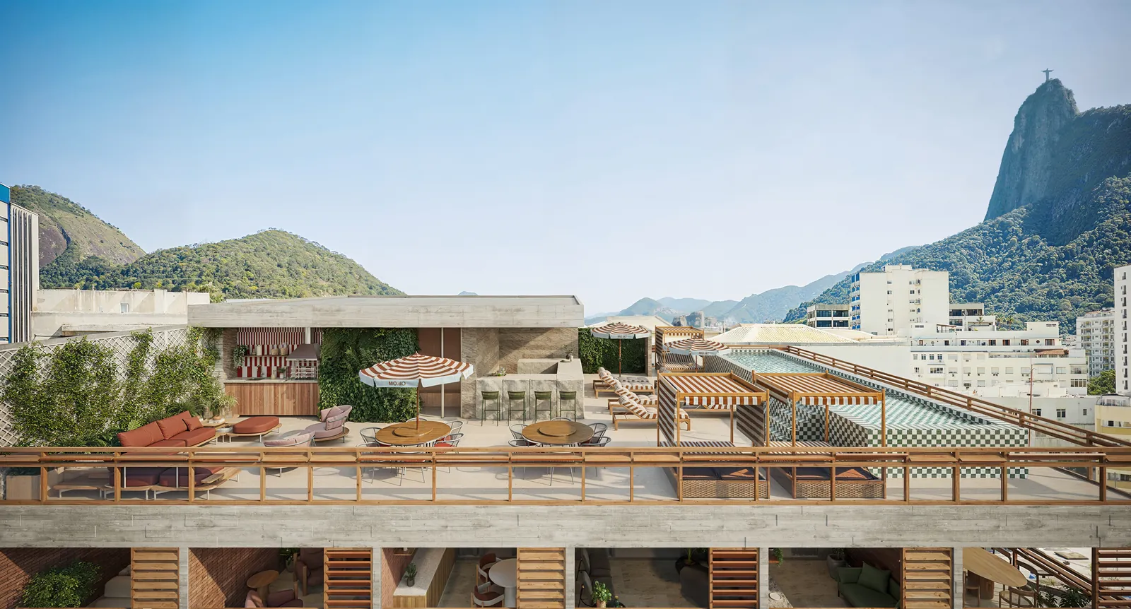 O rooftop visto de cima, com piscina, guarda-sóis e o Cristo ao fundo