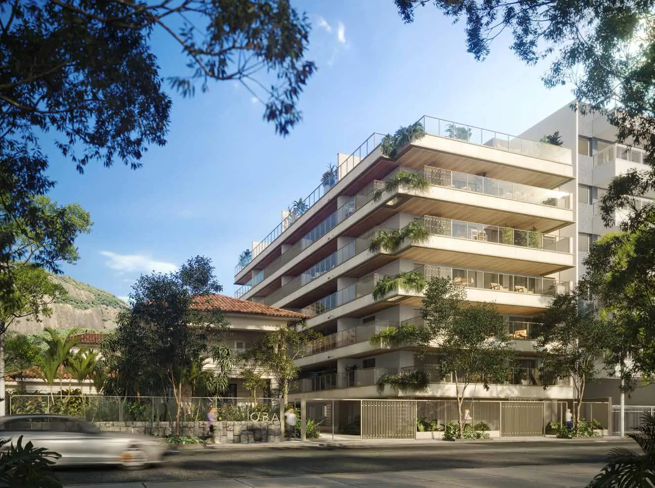 O edifício contemporâneo do Oba Urca, com varandas e a casa art déco ao lado