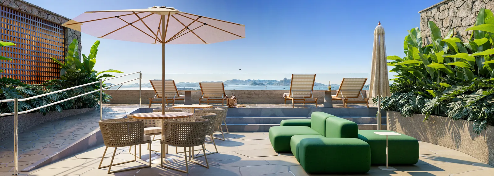 O lounge do rooftop do Oriá, com ombrelones e vista para a Baía