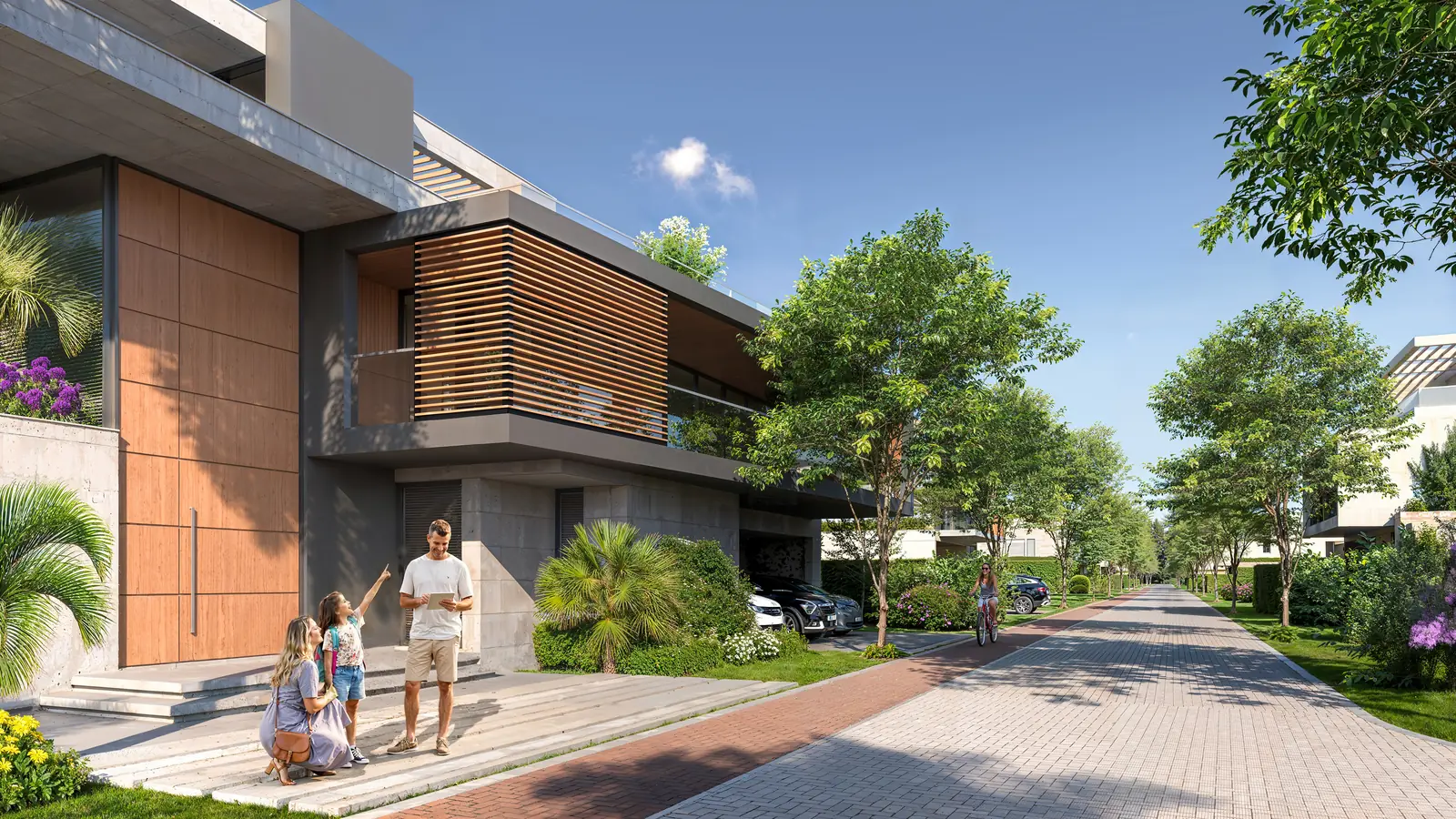 Rua interna arborizada, com casas contemporâneas sem muro frontal e uma família na calçada