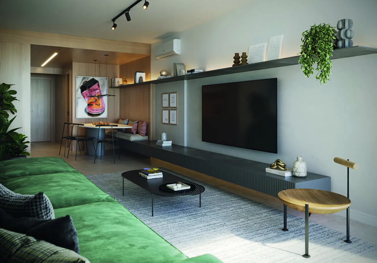 A sala de um apartamento do Oui Ipanema, com sofá verde e TV