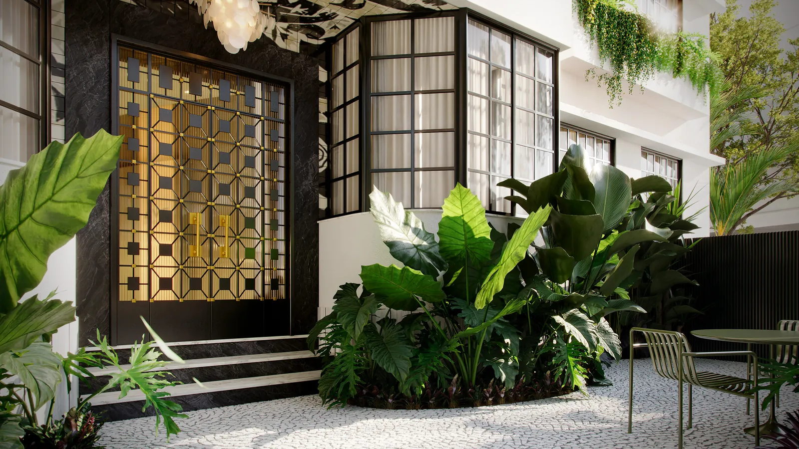 Detalhe da entrada do prédio art déco, com gradil dourado iluminado e plantas tropicais