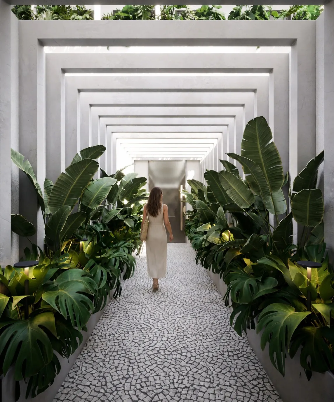 Corredor de acesso com piso de pedras portuguesas, plantas tropicais e pórticos brancos