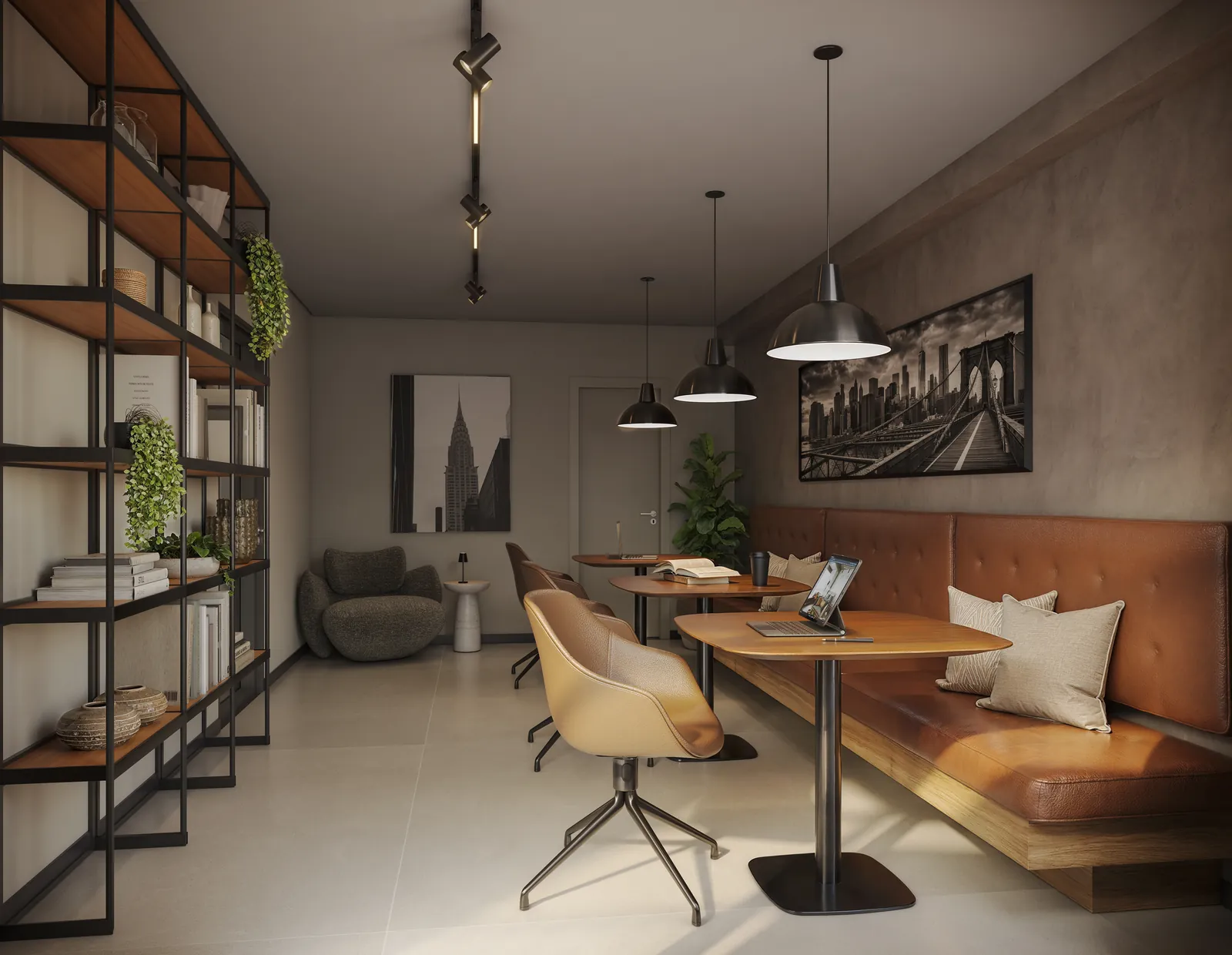 Coworking com sofá de couro, mesa e estantes de ferro