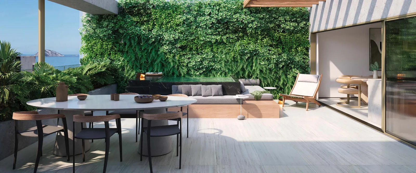 O terraço de uma cobertura duplex do Riô, com jardim vertical e mesa