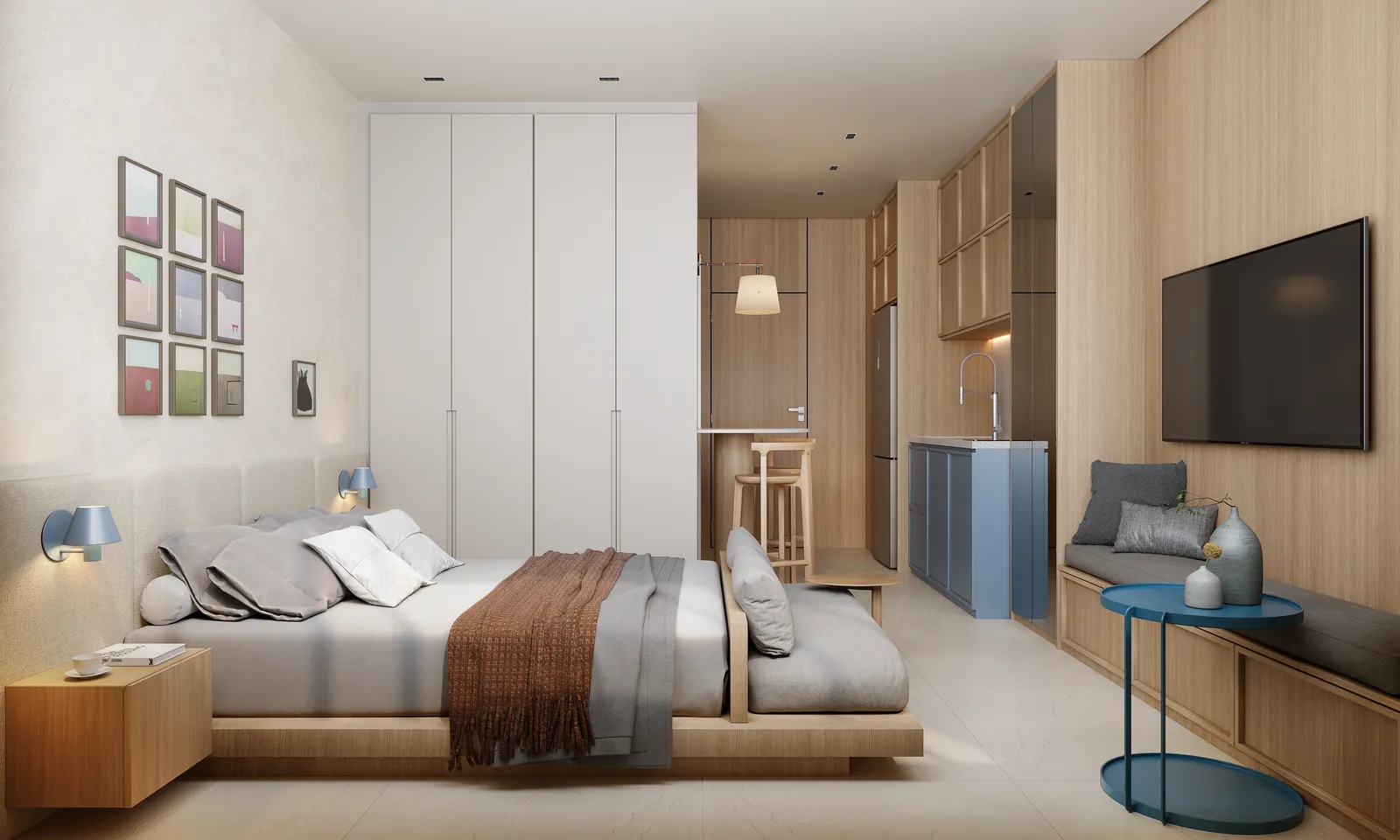 Studio decorado com cama de casal, cozinha compacta, bancada e TV