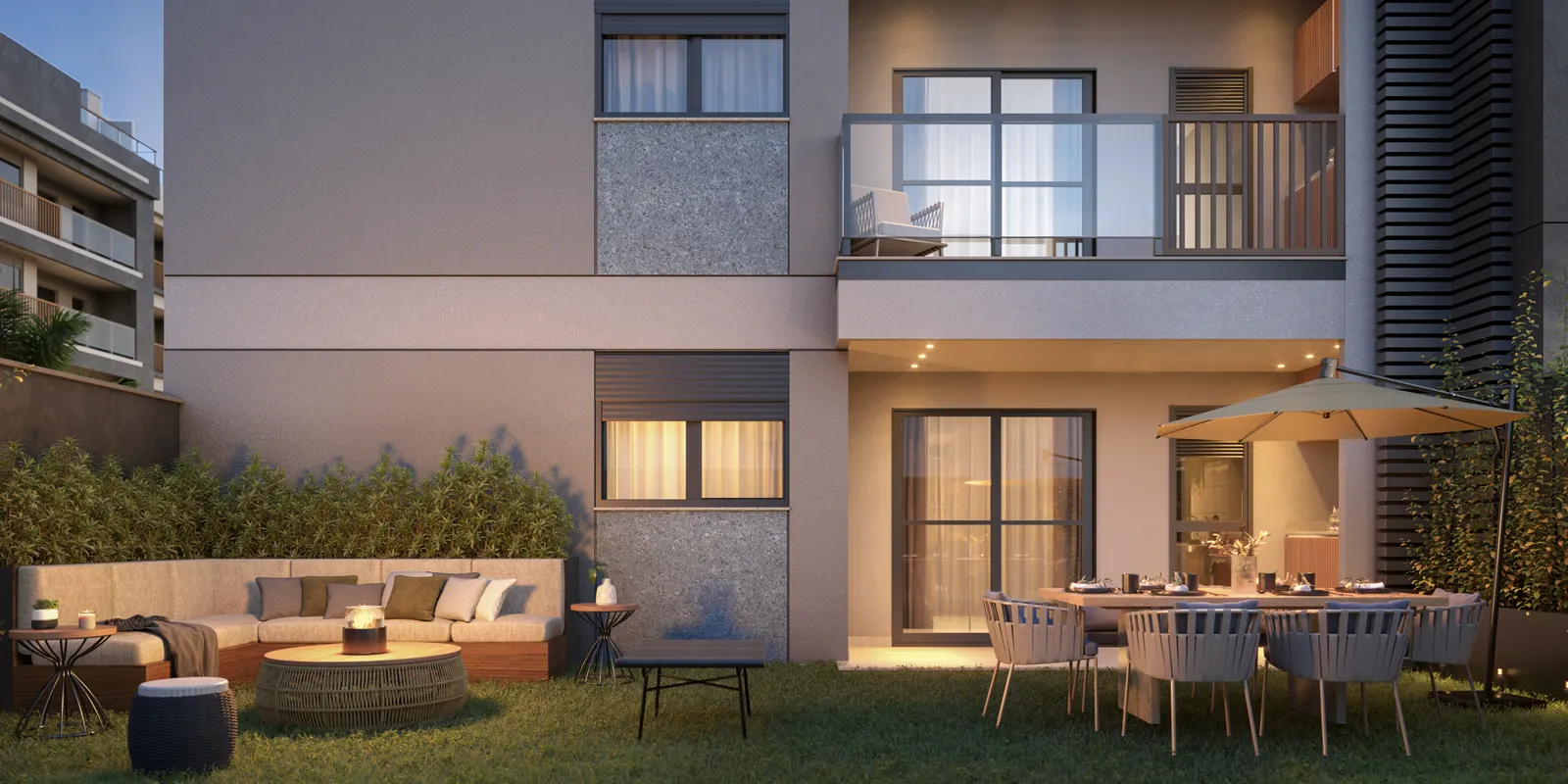 Área externa do garden com sofá, mesa e jardim