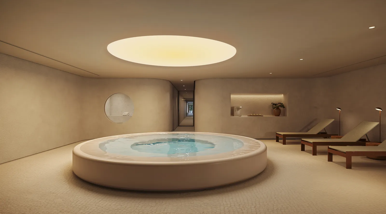 Spa com jacuzzi redonda sob uma claraboia, espreguiçadeiras e paredes de pedra clara