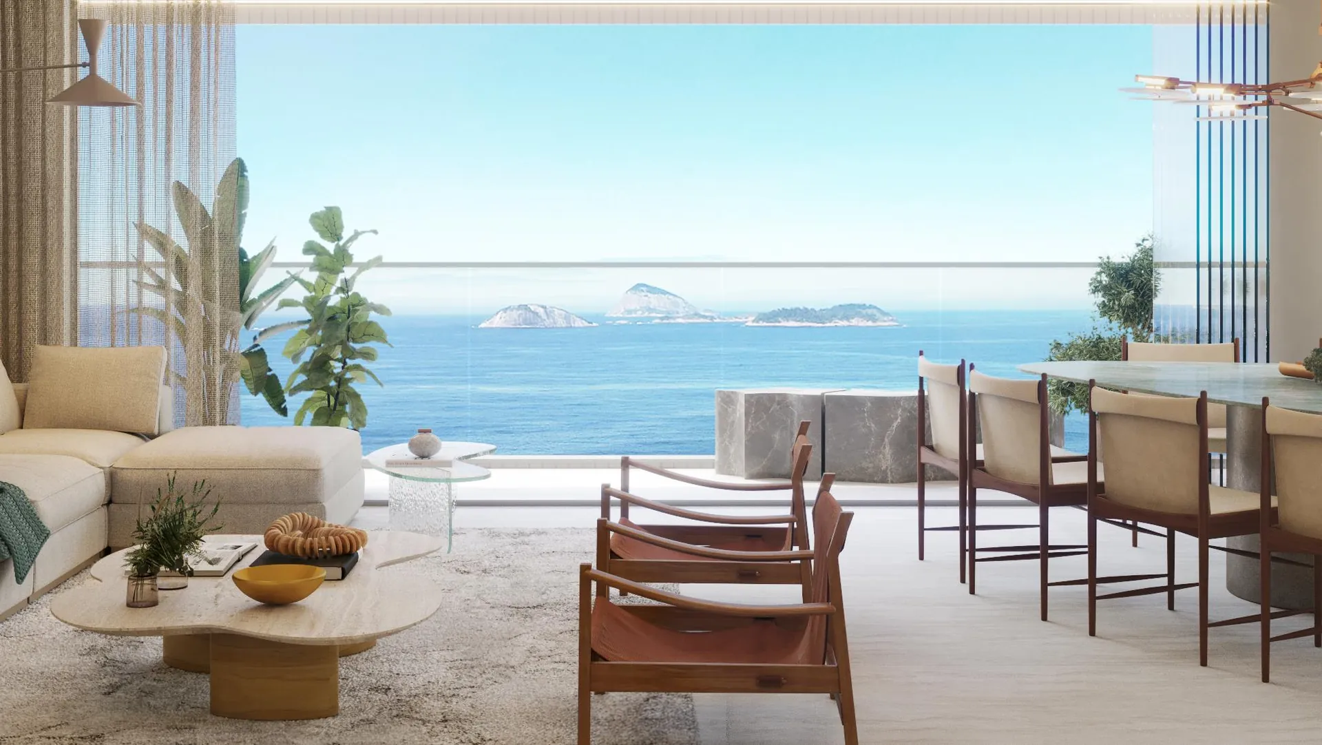 Sala do Vista Ipanema com sofá, mesa de jantar e a praia e as Cagarras pela janela